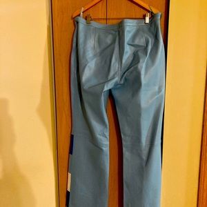 Light blue leather pants suit , jacket has detachable fur collar.